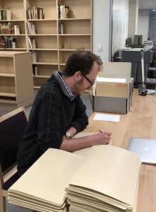 Patrick Doyle sitting at a table processing Presidential records